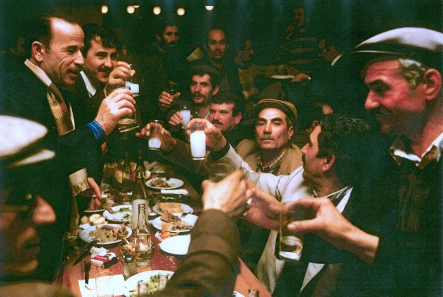 Camel owners in western Turkey toast each other on the eve of a camel wrestling tournament. Photo by George Simpson