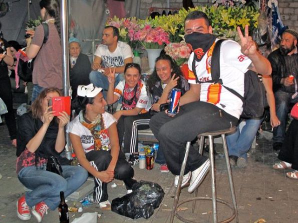 Protestors celebrate in front of a Taksim Square flower stall
