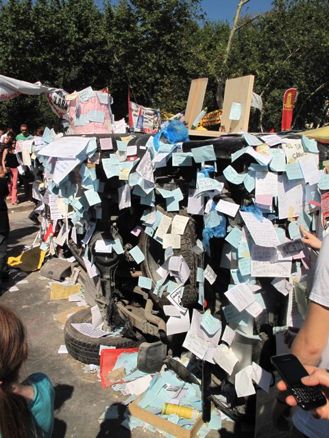 A pick-up truck overturned in the first night of protests has become a wish-list of protestors' demands - typically, an end to the concrete covers up 98.5 per cent of the city.